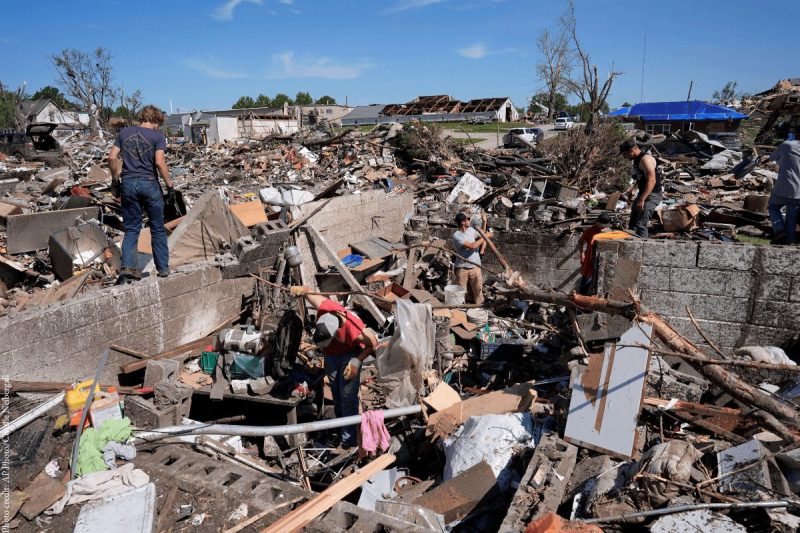 A photo of people picking through ruins left by the tornado that tore through Greenfield, Iowa in May 2024. This storm was warned and tracked by the NWS.