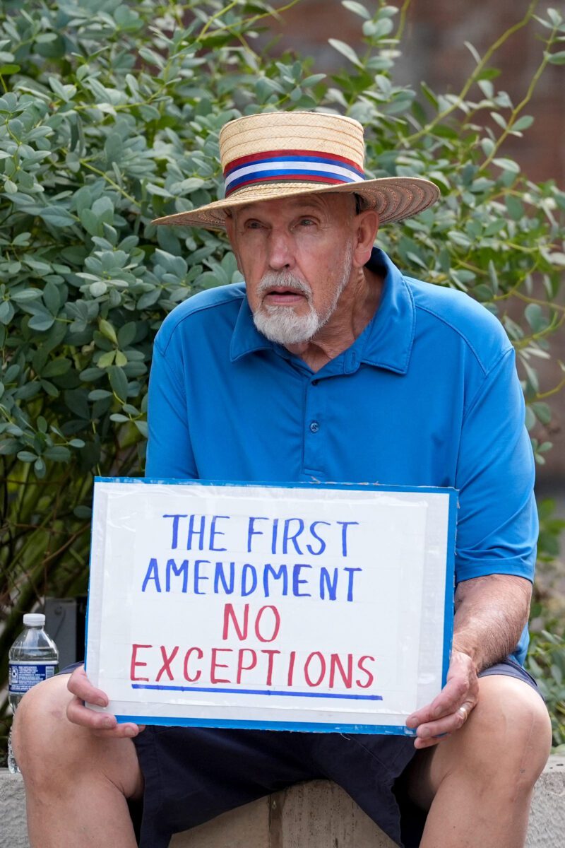 An attendee of a Free Speech Rally holds a sign in support of the First Amendment Oct. 1, 2025 on the Pedestrian Mall in downtown Iowa City, Iowa.