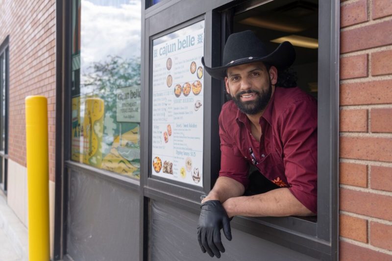 Owner Zack Hollier poses for a portrait in the drive-thru window at Cajun Belle on Thursday, April 10, 2025, in Johnston. (USA Today via Reuters Connect)